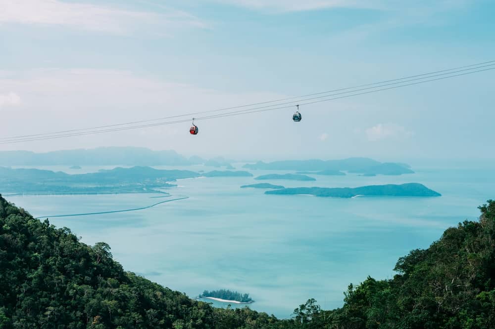 Cable cars above Langkawi's forested hills, with coastal islands in the distance